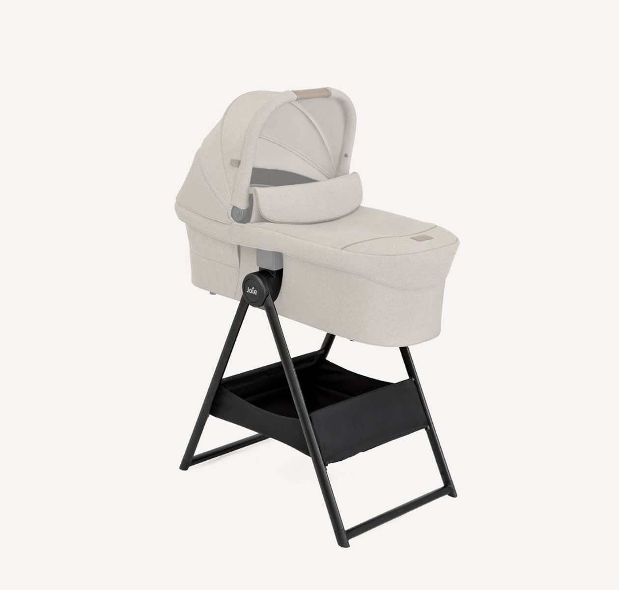 Joie carry cot stand at a profile angle with the carry cot attached to it