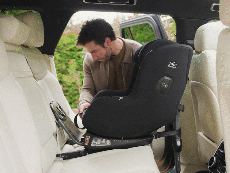 Dad installing the Joie Signature i-Prodigi Pro car seat using the ISOFIX connectors and load leg