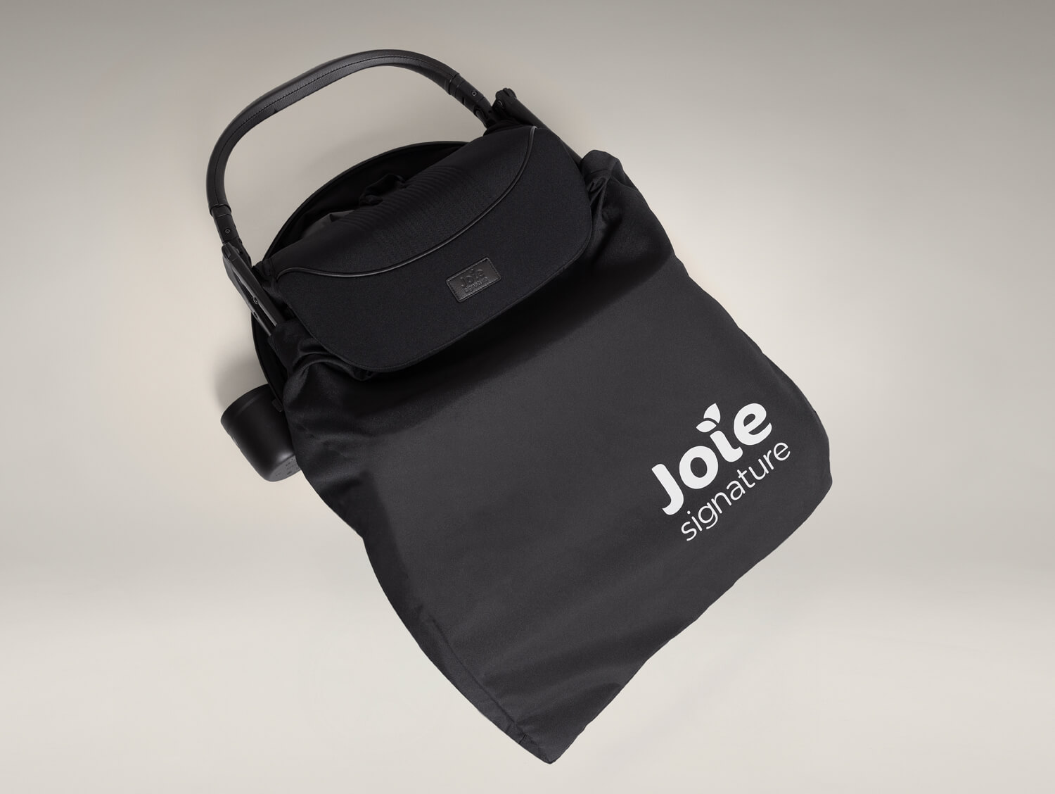 Convenient black travel bag with the folded parcel pop travel strollerstored inside.
