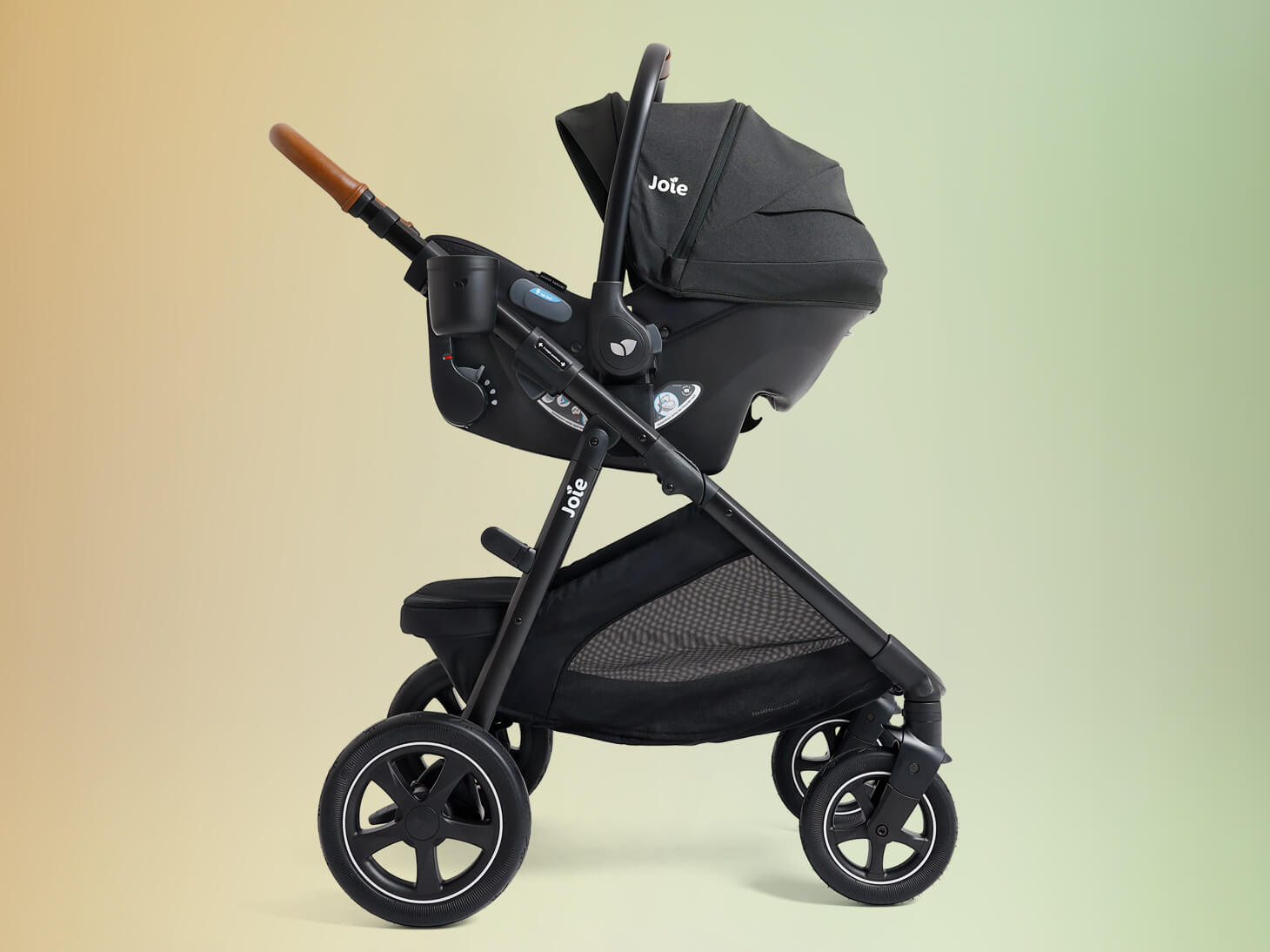 Ginger DLX travel system in black on yellow to green gradient background.
