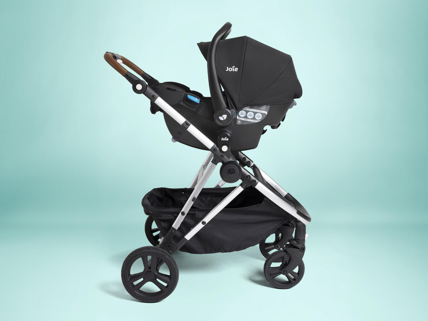 Profile angle of Joie™ infant car seat adapters for Mockingbird 2.0 Stroller used with rue on light blue background