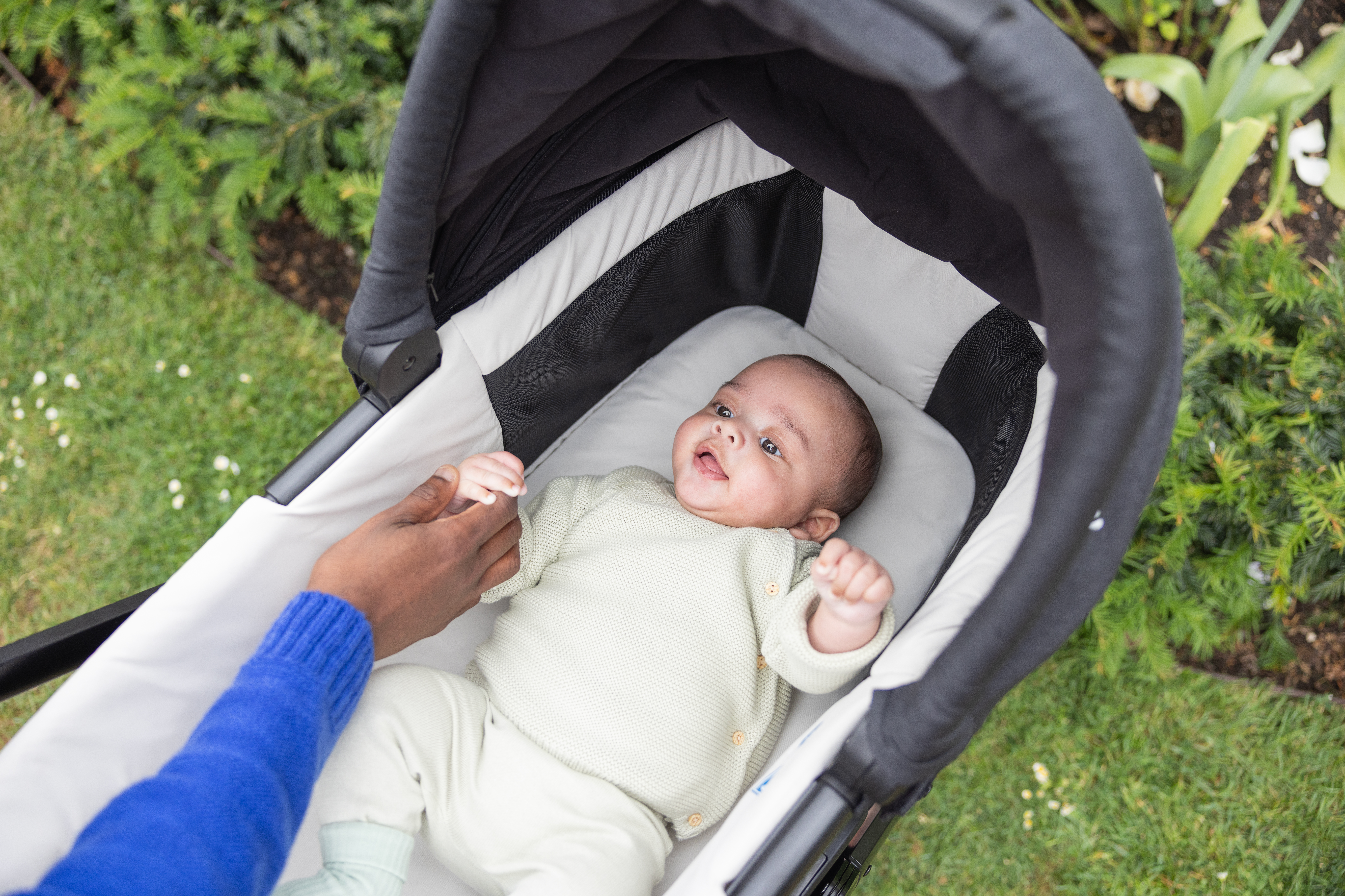 Infant relaxing comfortably inside the cozy chrome carry cot attached to the chrome 3 pram
