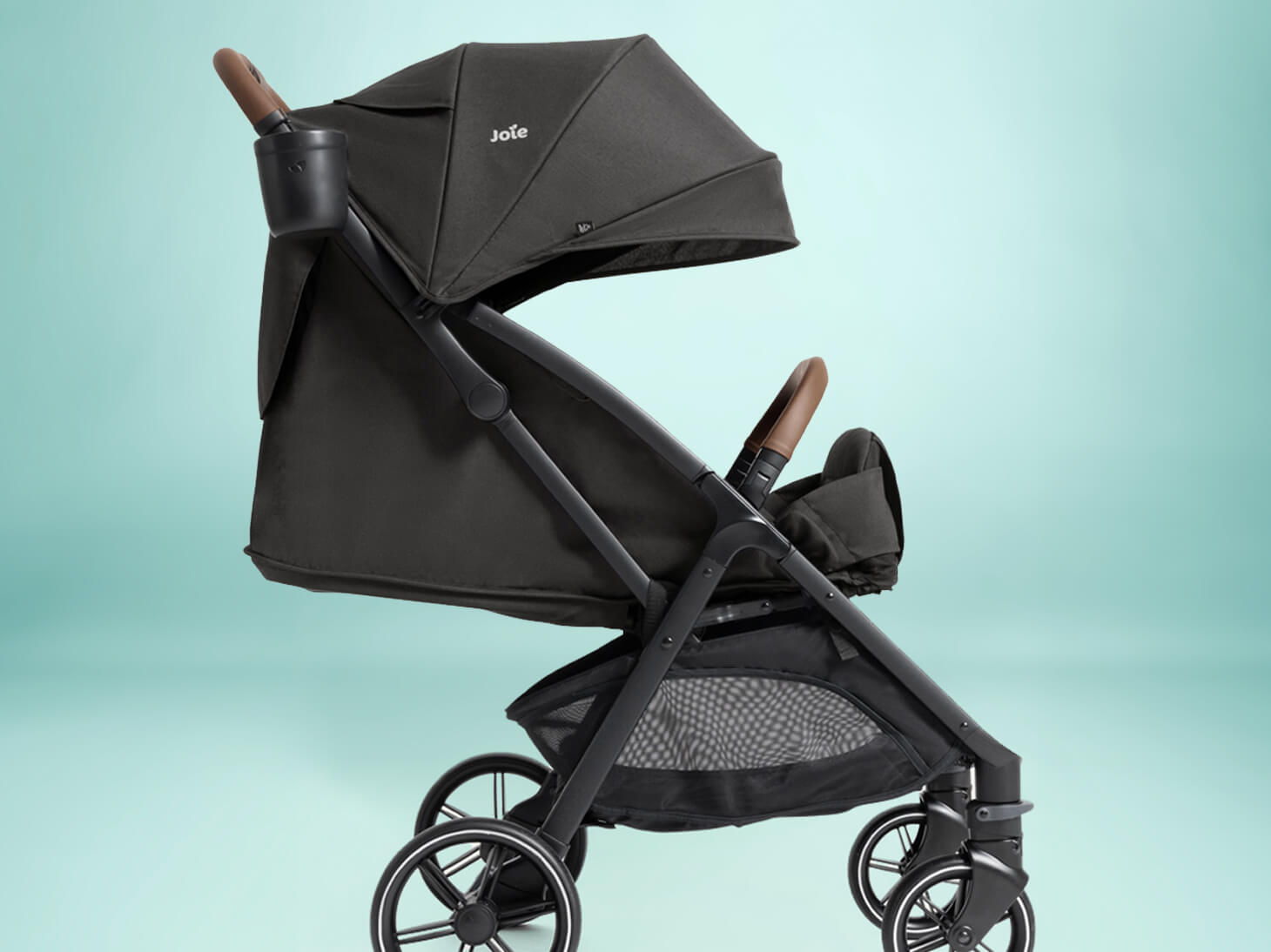 Profile angle nutmeg compact stroller in thunder with full recline and occupant retention on white background
