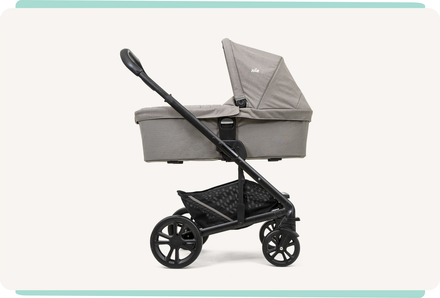   Joie chrome carry cot in light gray in profile on a pram. 