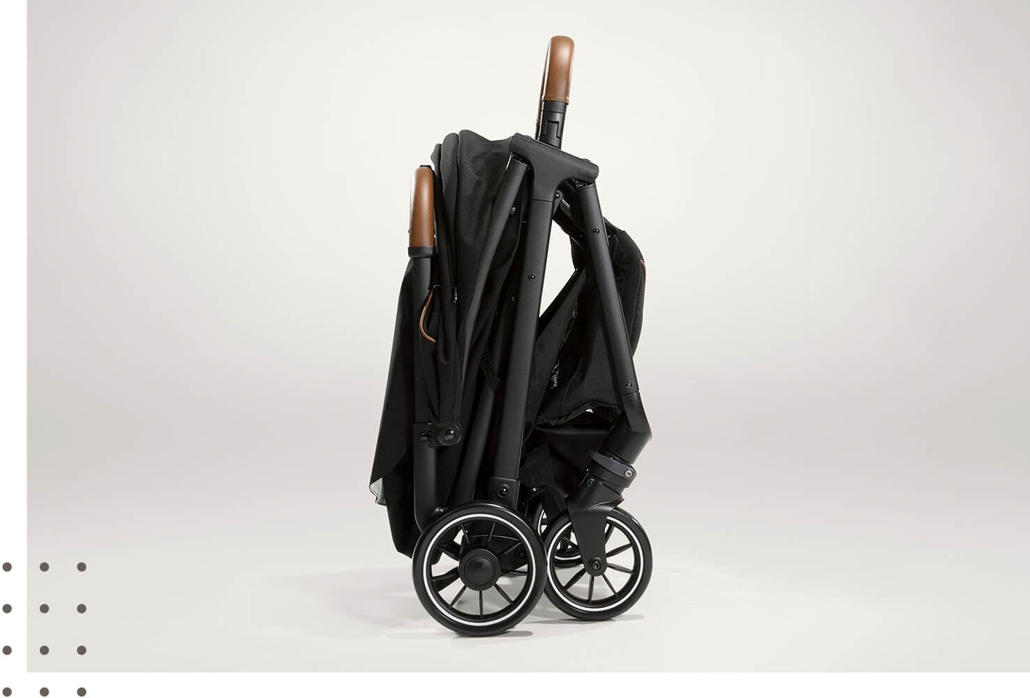 A folded Joie Parcel pushchair on a taupe background.