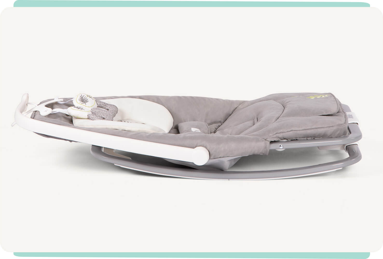 Grey patterned dreamer Joie bouncer lying flat on the ground to display compact feature.