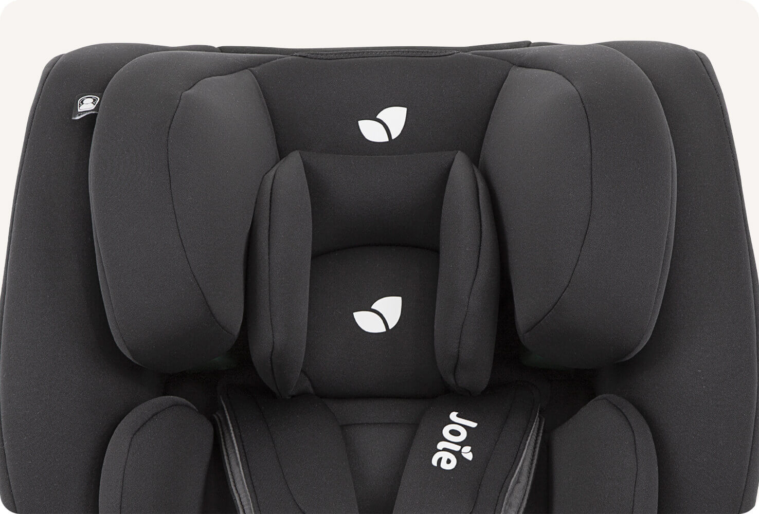 Closeup on the headrest area of a black Joie Every Stage R129 car seat.