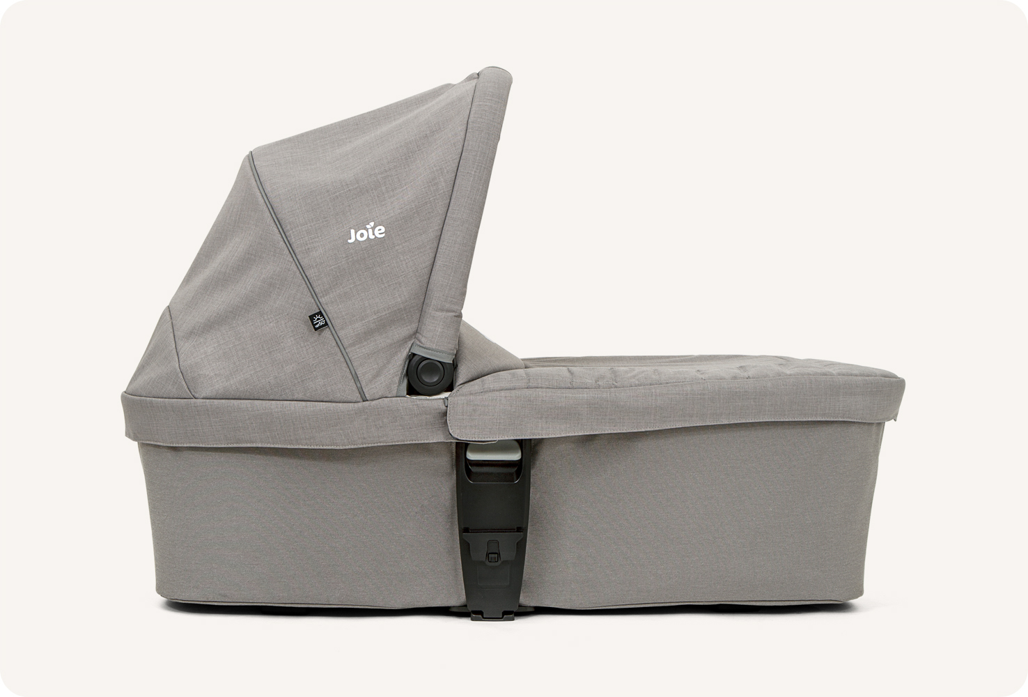   Joie chrome carry cot in light gray in profile. 