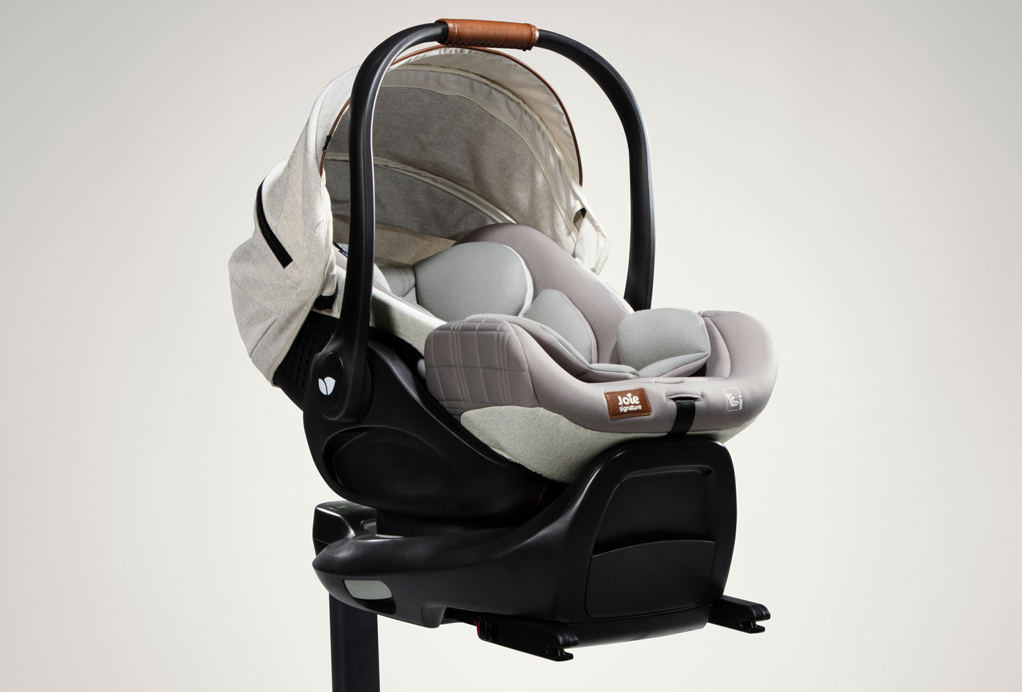 Gray Joie Signature I-Level Recline infant car seat attached to an ISOFIX base, facing toward the right at an angle.