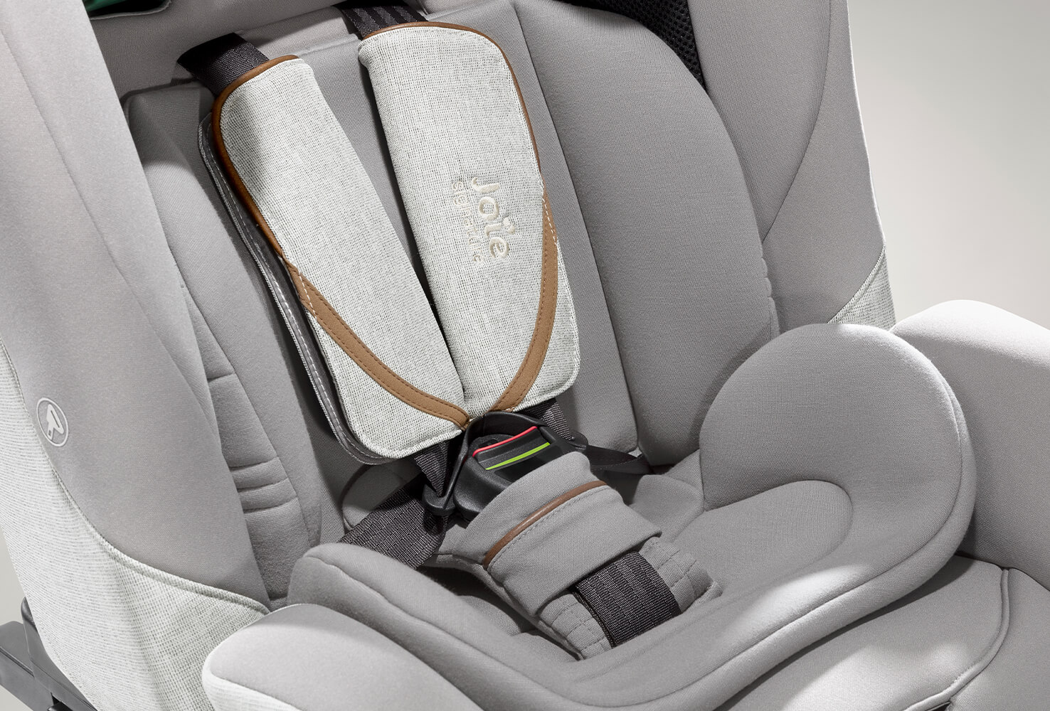 Closeup on a gray Joie I-Plenti car seat harness.