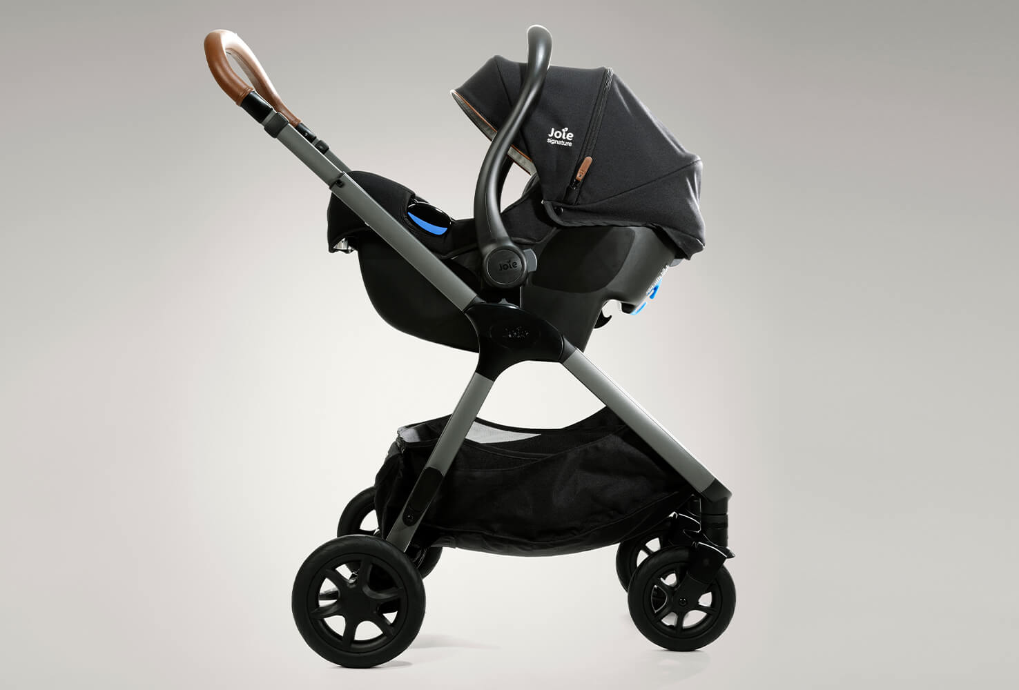 Black Joie I-Gemm infant car seat in profile facing to the left on a stroller.