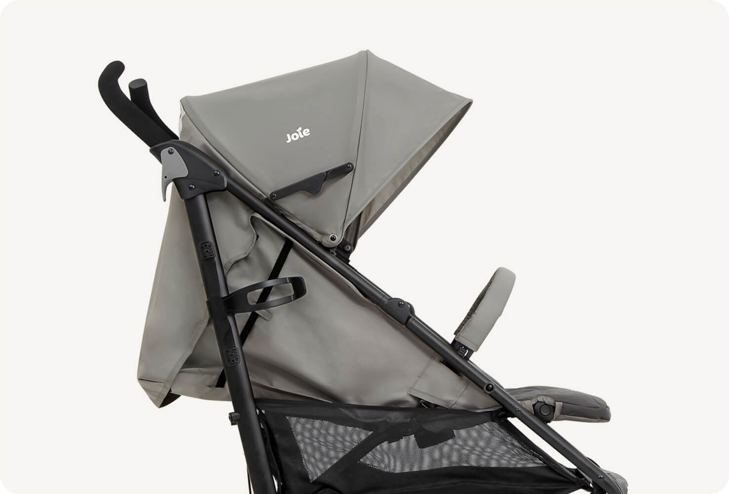   A closeup of the Joie Brisk LX stroller in two tone gray, in profile facing to the right with the seat fully reclined.