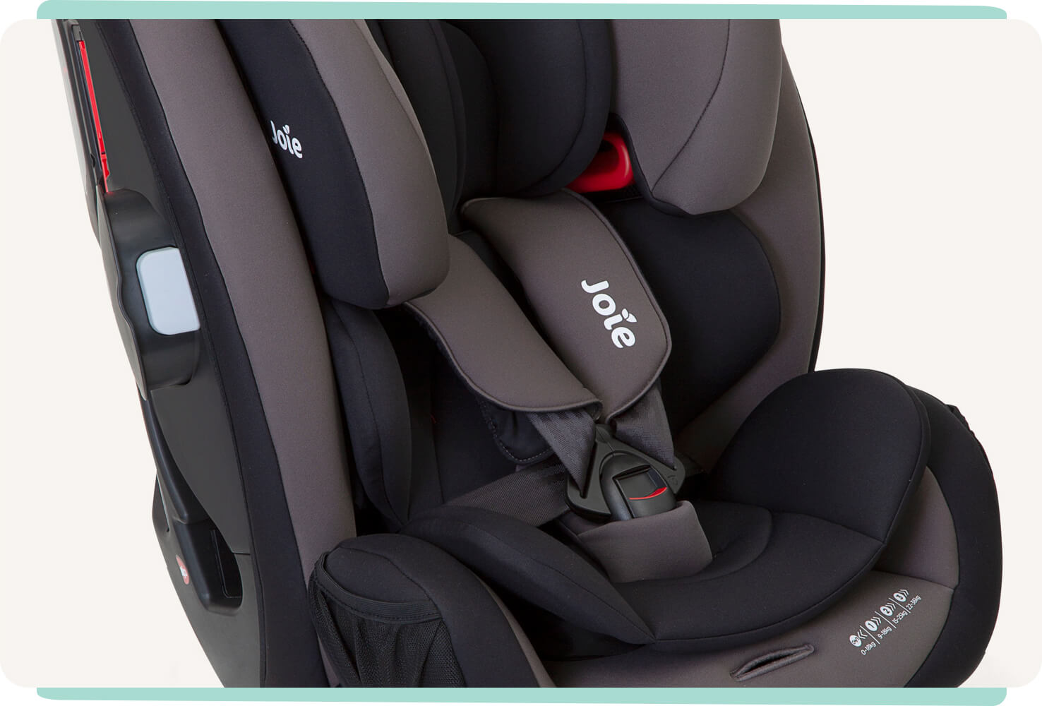  Closeup of a black and gray Joie Every Stage car seat showing the 5-point harness and infant insert.