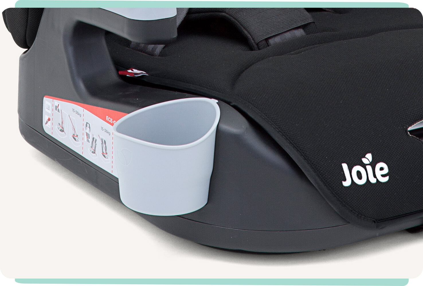  Closeup of gray plastic cupholder on a black Joie Elevate booster car seat.