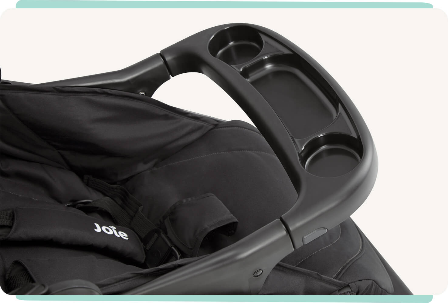 Close up of the child tray on the Joie muze lx stroller in black.