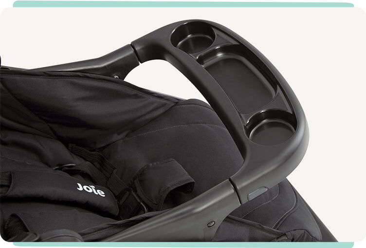 Close up of the child tray on the Joie muze lx stroller in black.