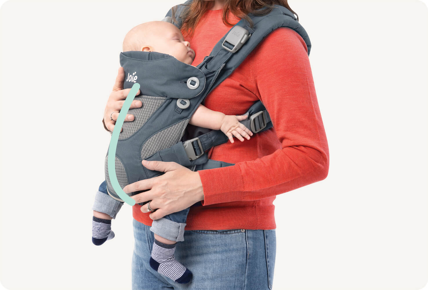  Closeup of a baby in a blue Joie Savvy 4in1 baby carrier with a mint colored line indicating the C shape of the baby’s spine