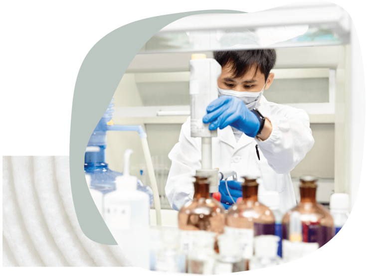 Scientist testing chemicals in a lab.