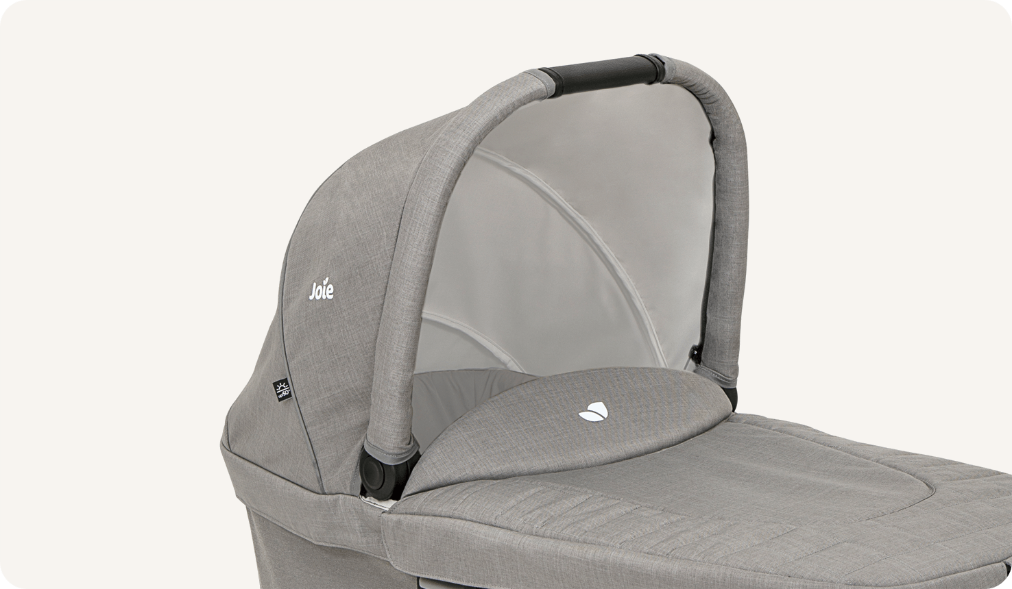 Joie chrome carry cot in light gray at an angle from the front.