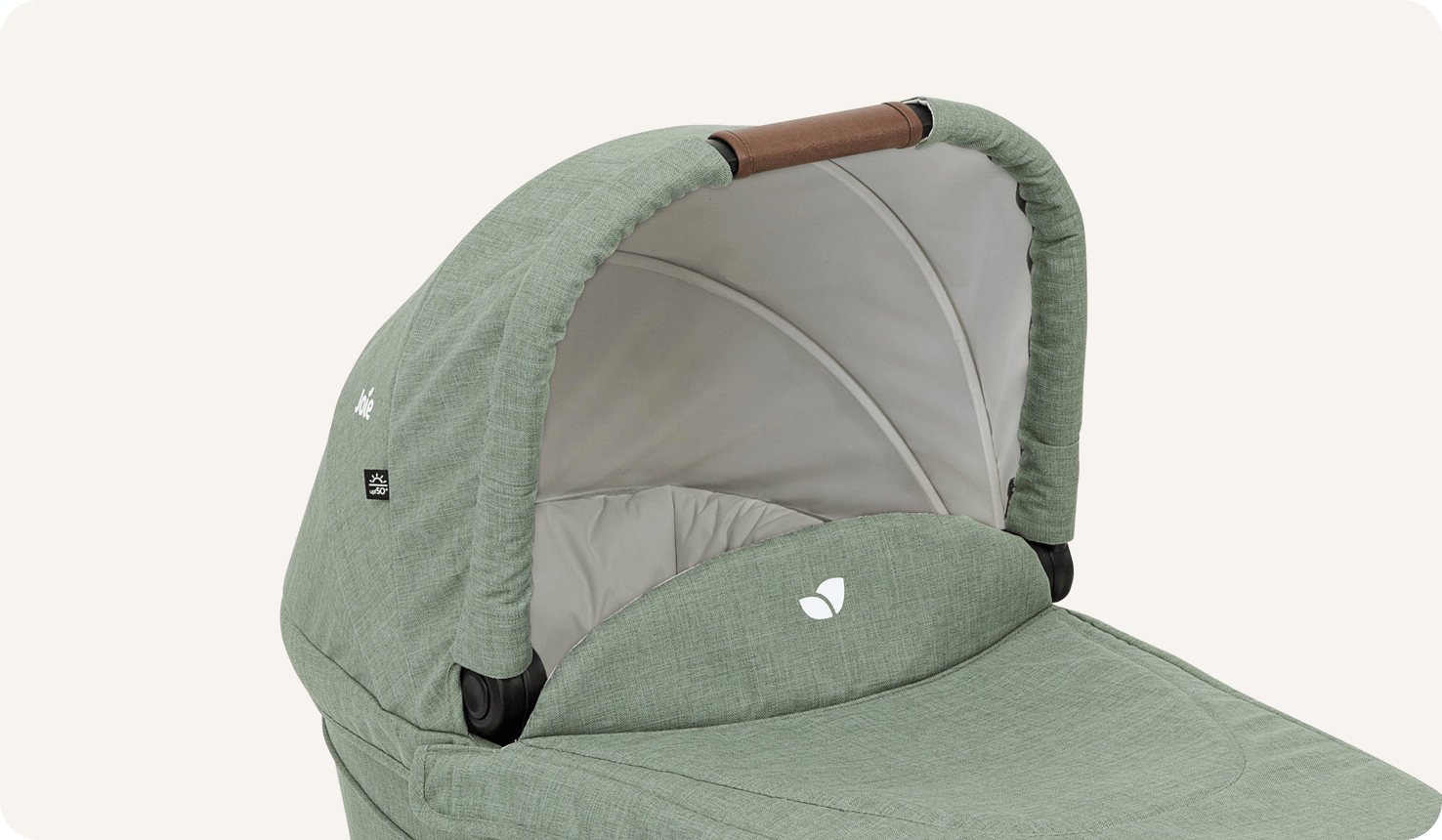  Joie Ramble xl carry cot in light green on a side angle looking into bassinet. 