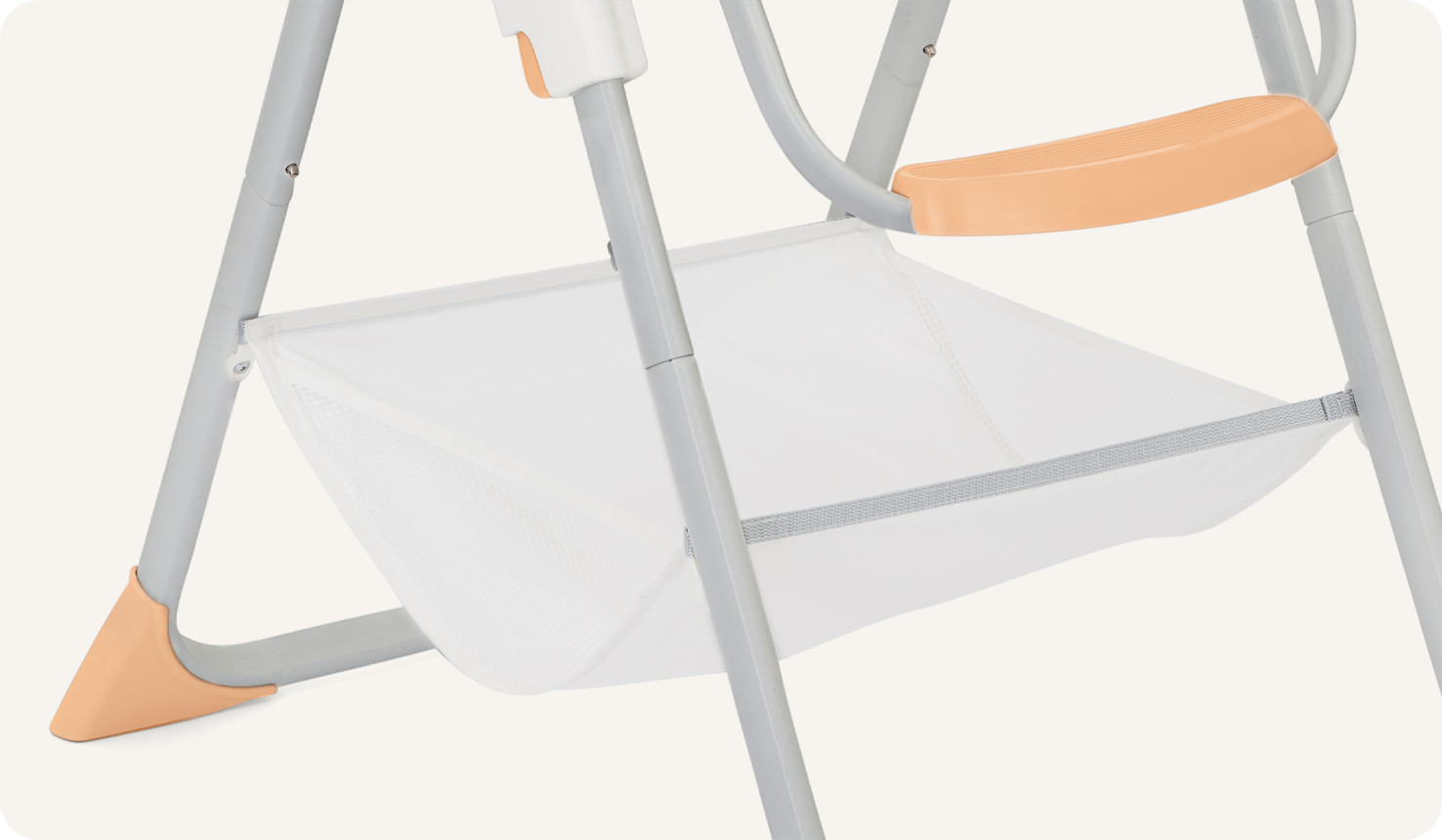  Close up of the storage basket towards the bottom of the legs on the Joie highchair Snacker 2in1.