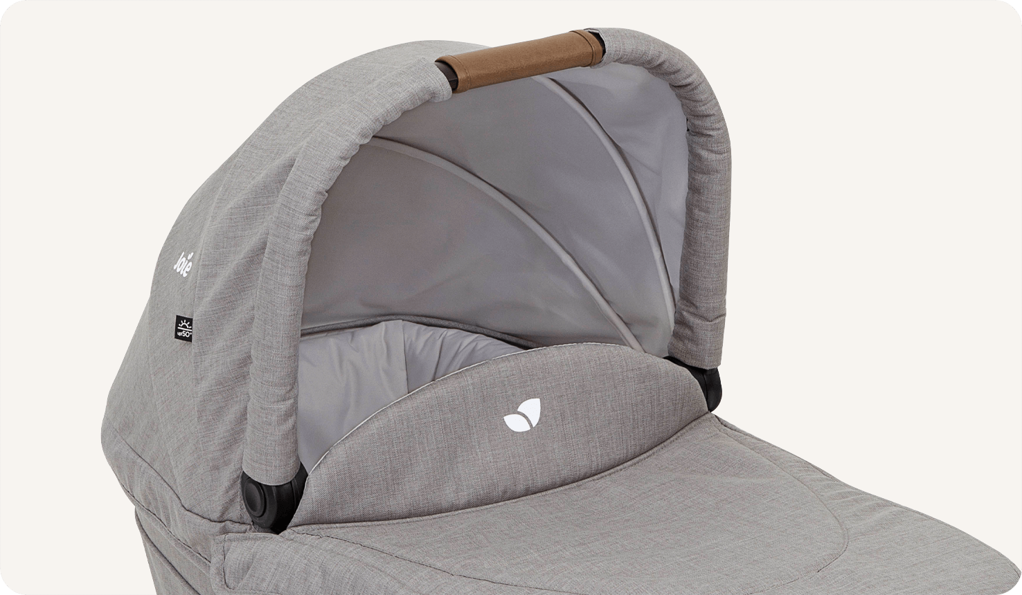  Joie Ramble xl carry cot in light grey on a side angle looking into bassinet. 