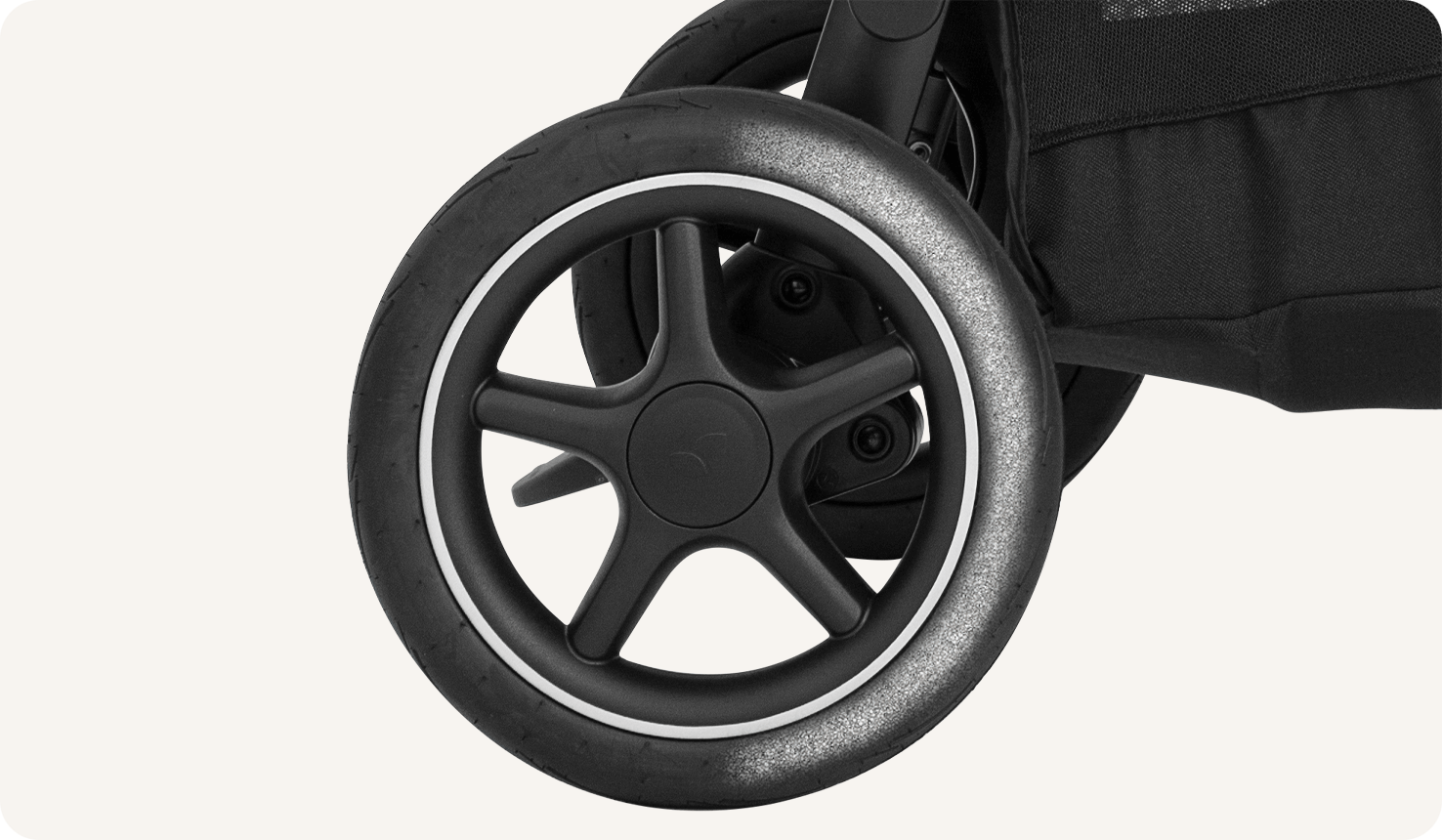 Zoomed in view of the wheel on a Joie versatrax pram.