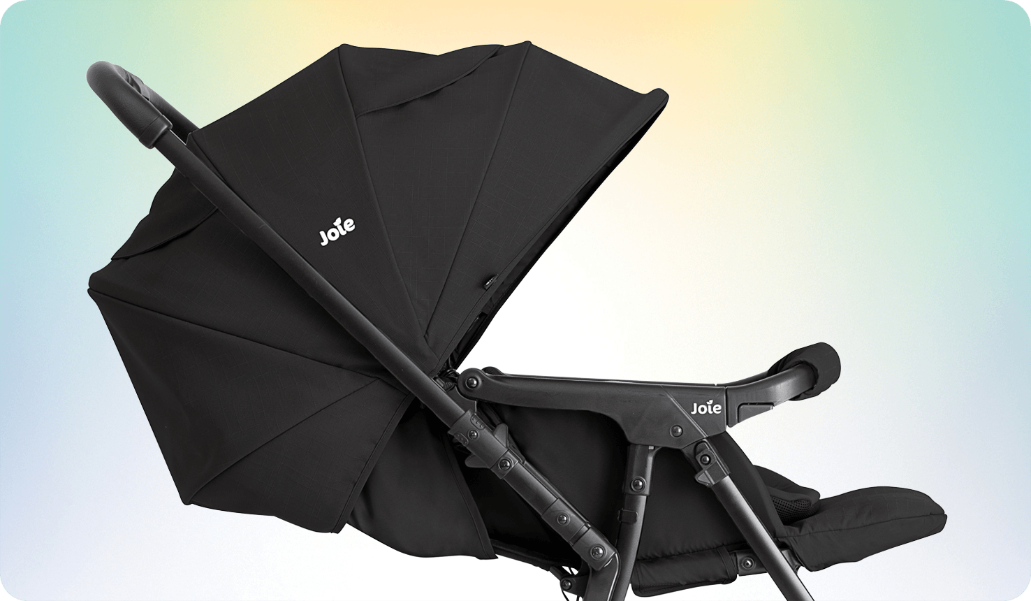 Side view of the Joie sma baggi 4WD stroller in black with the toddler seat's canopy fully extended and world-facing seat with the reversible handle feature and lifted leg rest.
