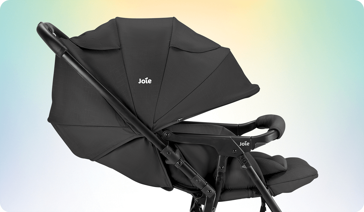 Side view of the Joie sma baggi 4WD stroller in black with the toddler seat's canopy fully extended and world-facing seat with the reversible handle feature and lifted leg rest.