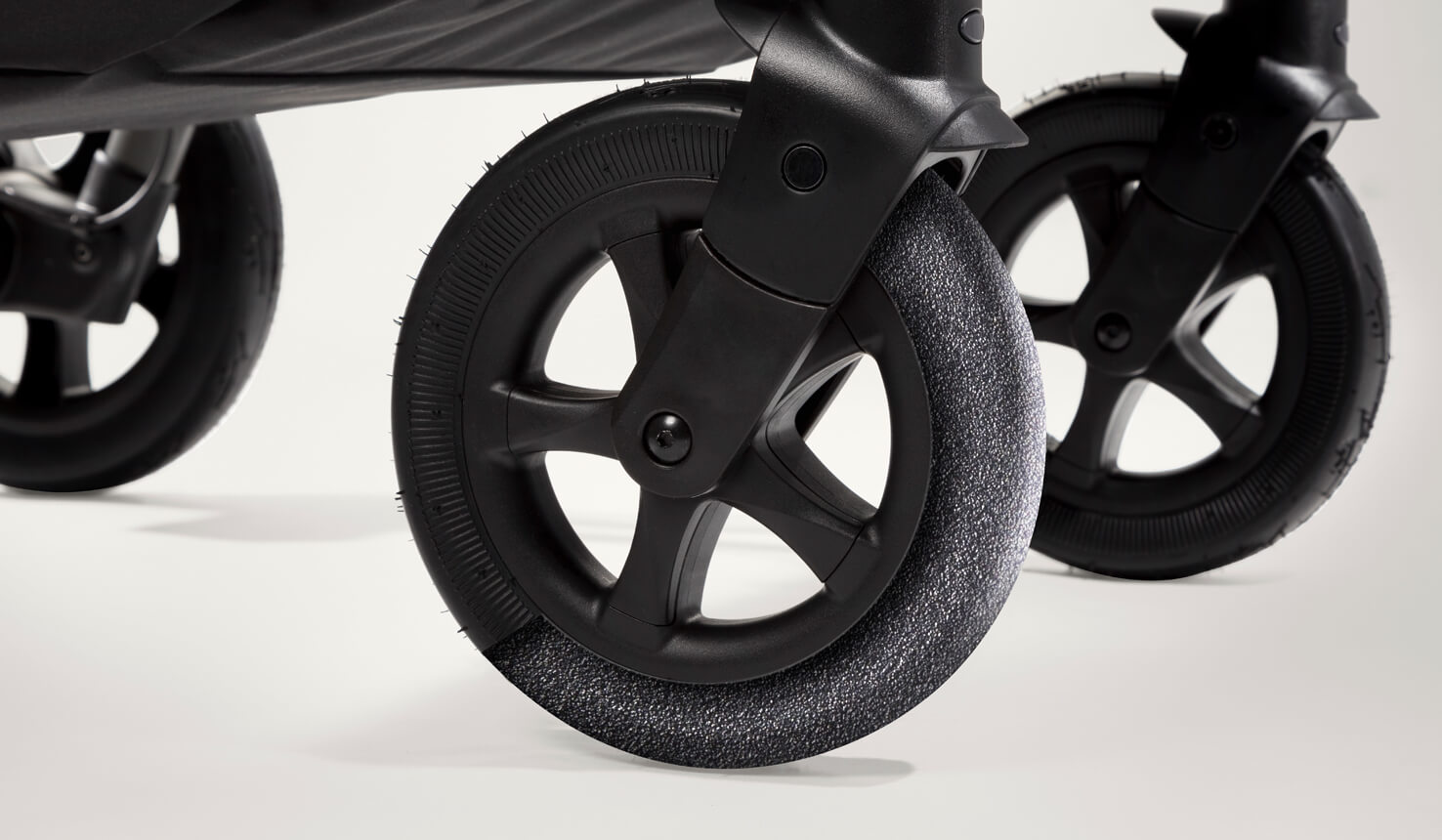 Joie aeria pram tyres demonstrating foam filled rubber tyres. 