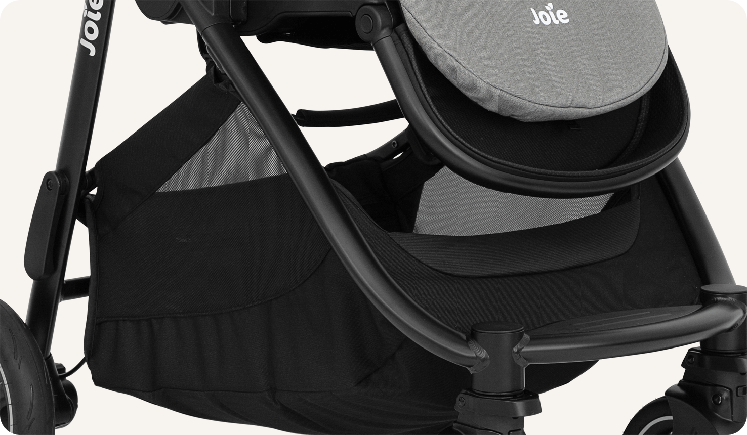 Zoomed in view of the storage basket on a Joie versatrax pram.