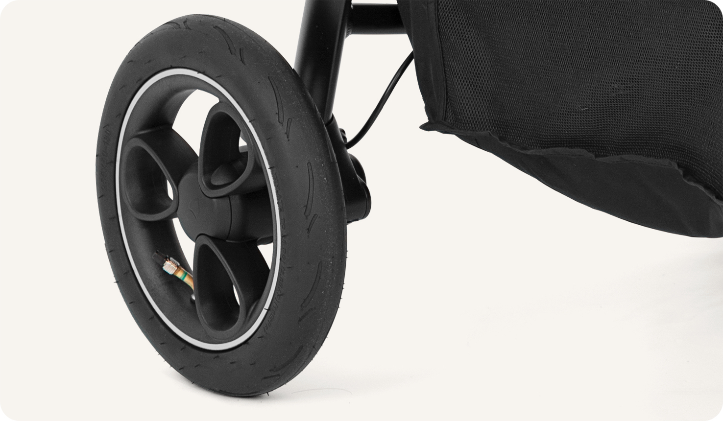 Joie litetrax pro air stroller in gray close-up of puncture proof tyre. 