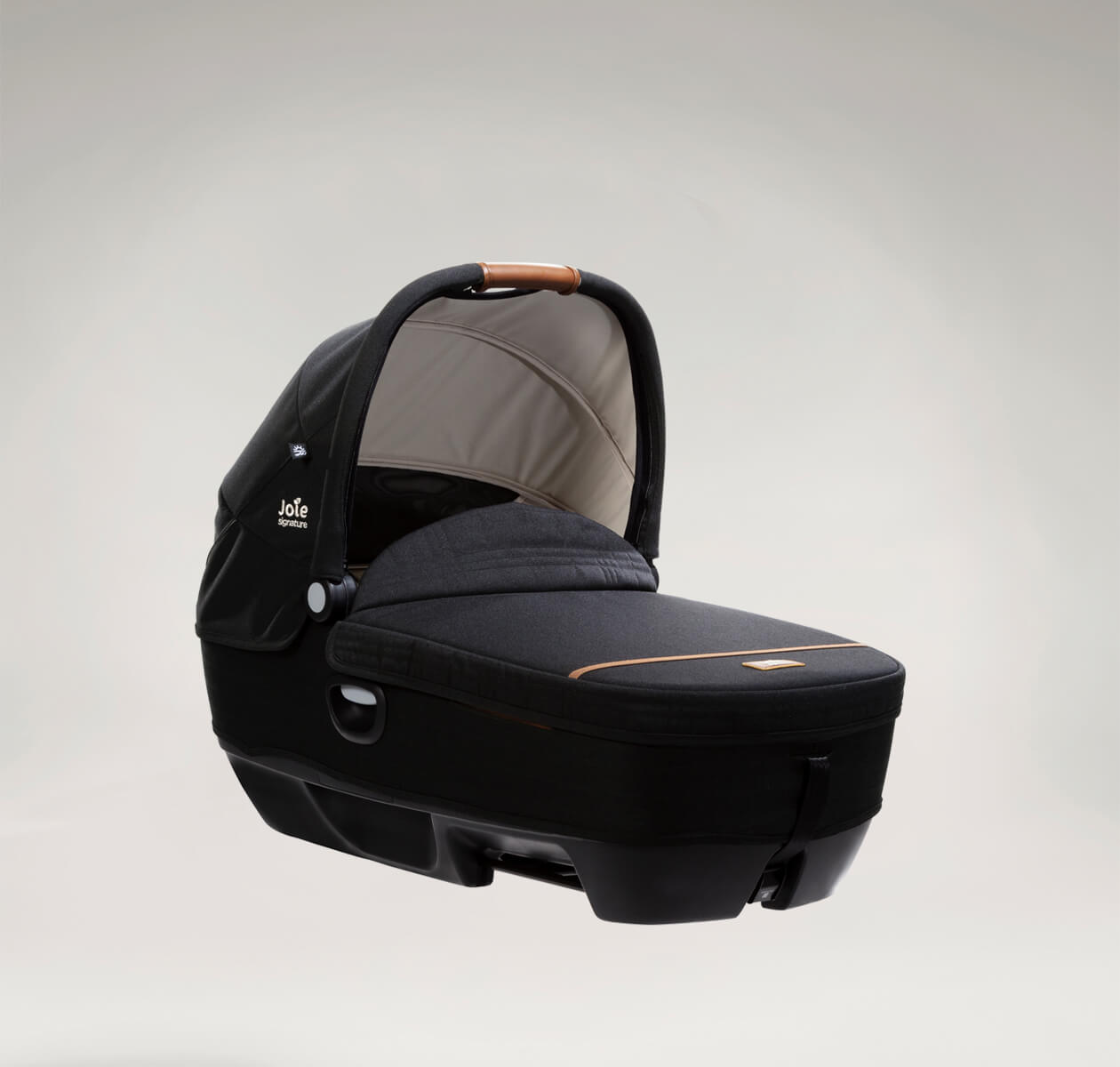  Joie Signature calmi R129 car cot in the color black eclipse with the canopy up and protective cover on facing a right angle