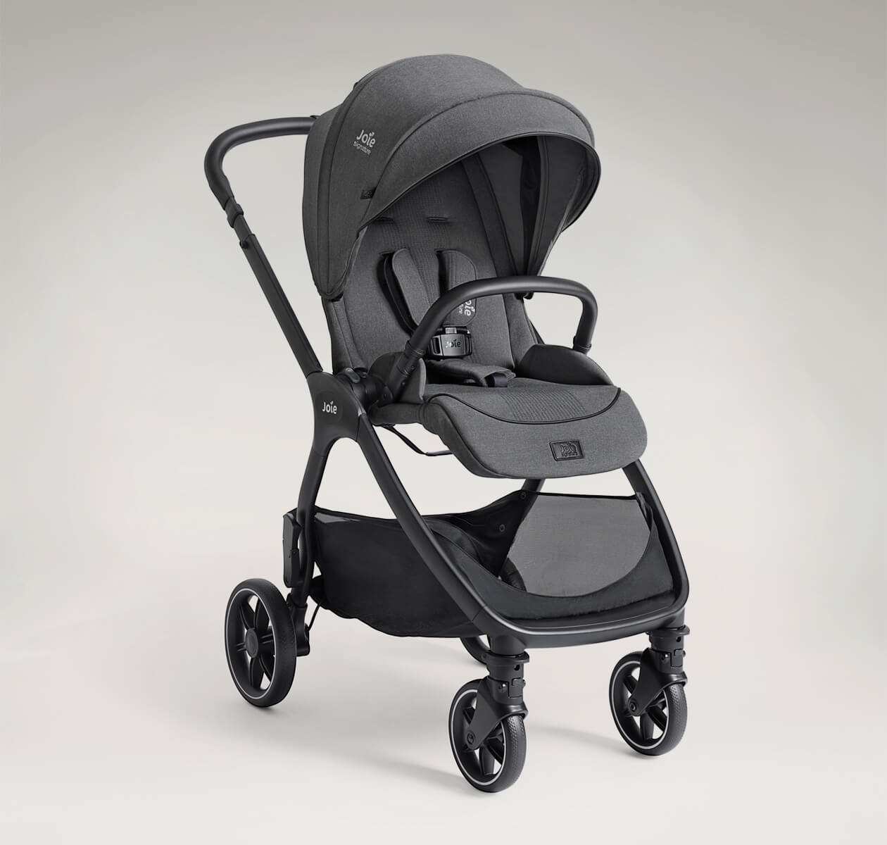 Joie Signature valora pram at an angle in world-facing mode in grey fashion on a taupe background