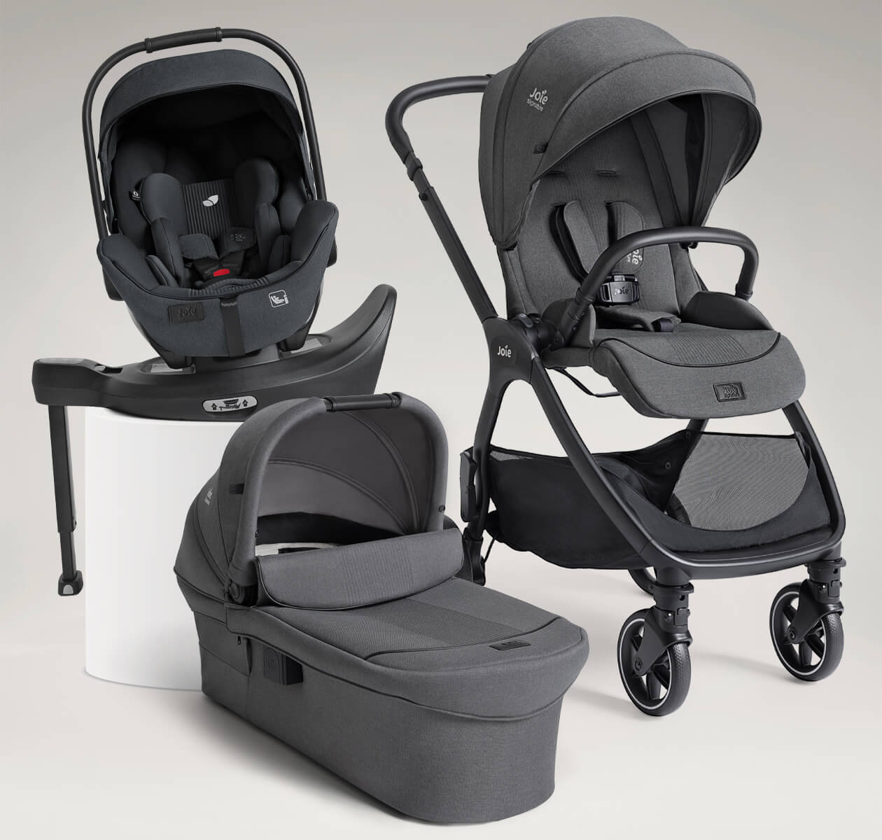 Joie Signature valora travel ready bundle including valora pushchair, i-Level Pro infant car seat, ramble xl carry cot all in grey, and i-Base encore spinning car seat base in black.

