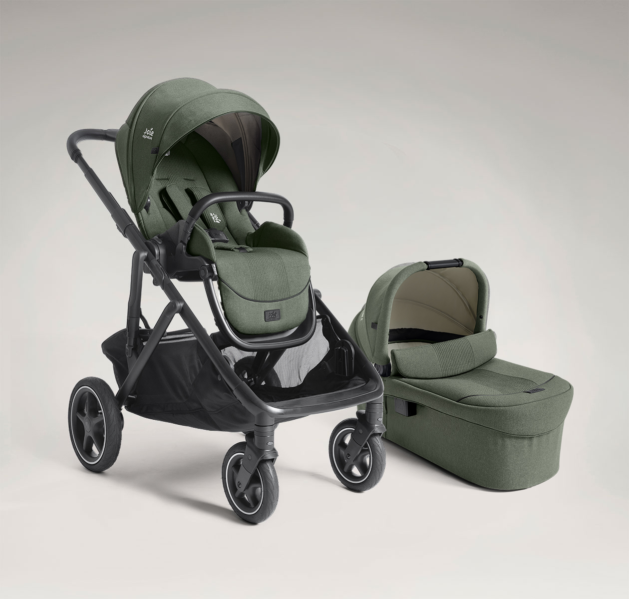 Joie signature versiti pushchair and ramble xl carry cot in green positioned at a right angle.
