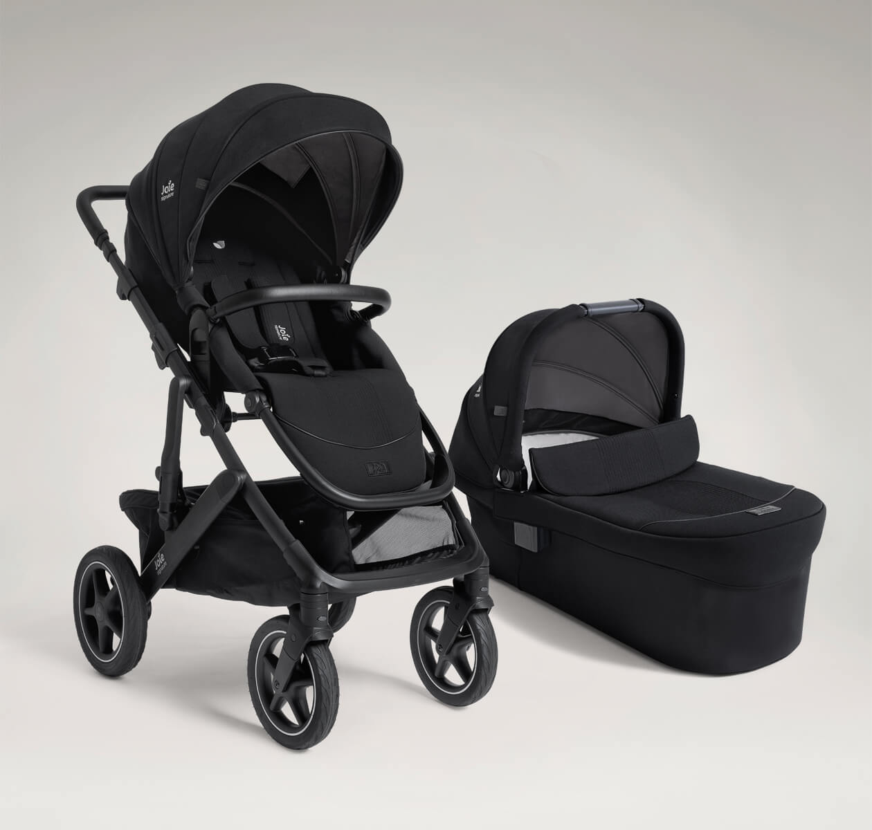 Joie vinca pushchair and ramble xl carry cot in black at a right angle.
