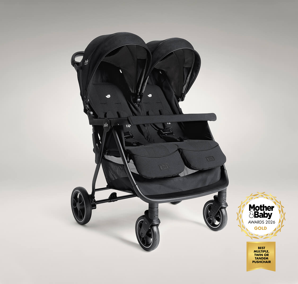 Joie Signature estrella pushchair in black, positioned at a right angle. The image also features a logo indicating that the product is a 2026 mother and baby awards gold winner for best multiple, twin or tandem pushchair.