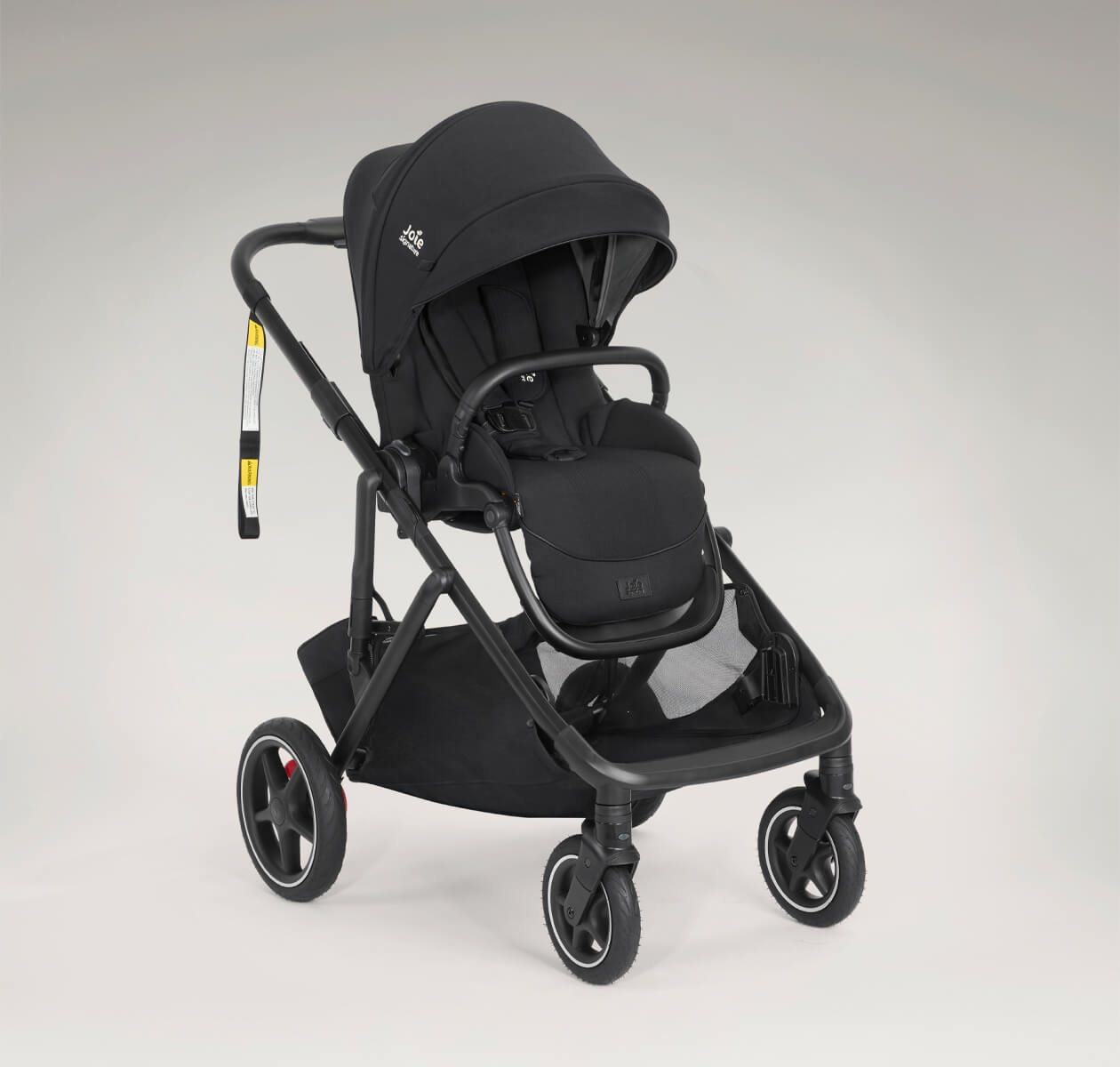 Joie Signature versiti pram in eclipse black positioned at a right angle.
