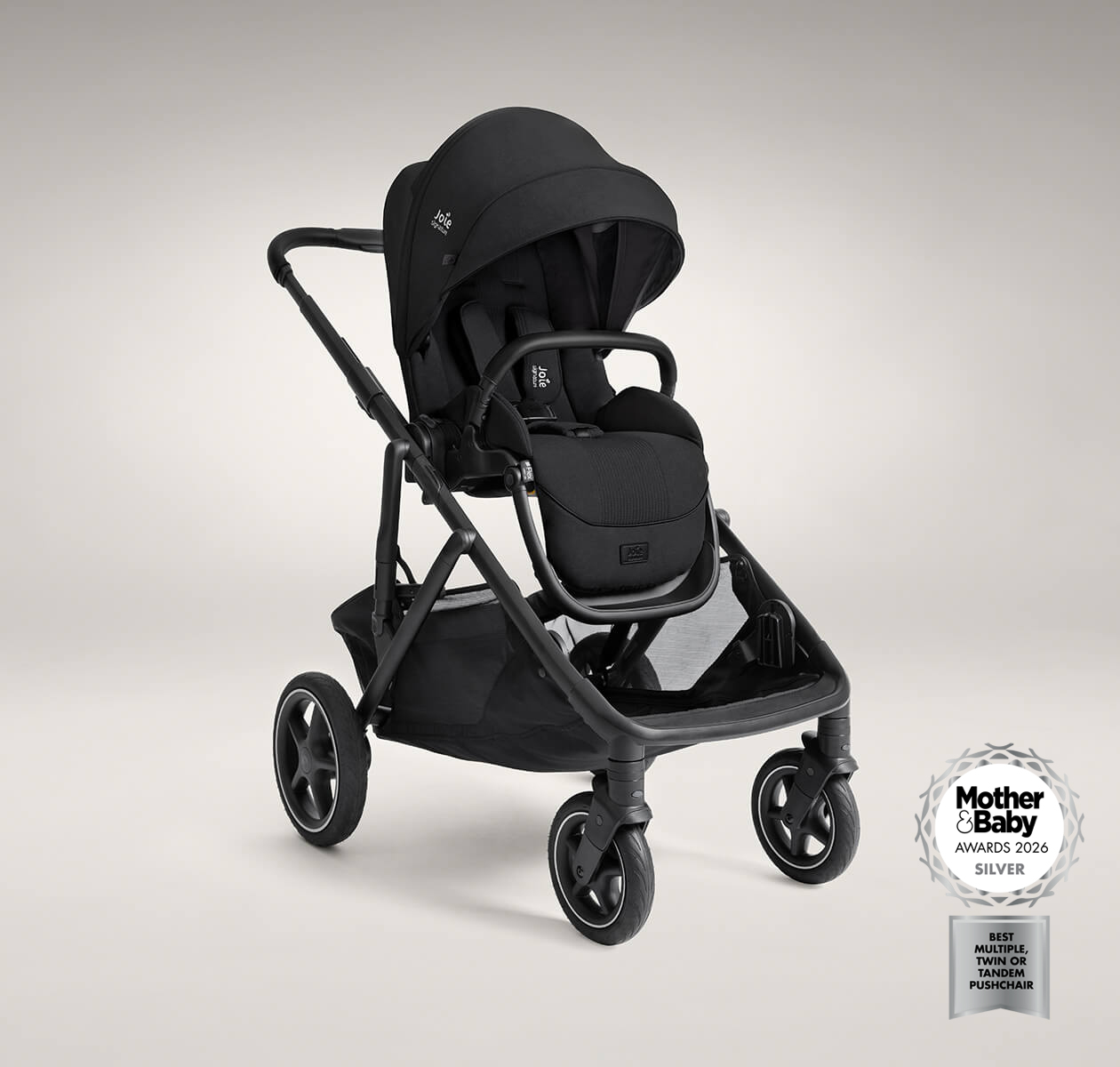 Joie Versiti pushchair in black positioned at a right angle. The image also features a logo indicating that the product is a 2026 mother and baby awards silver winner for best multiple, twin or tandem pushchair.