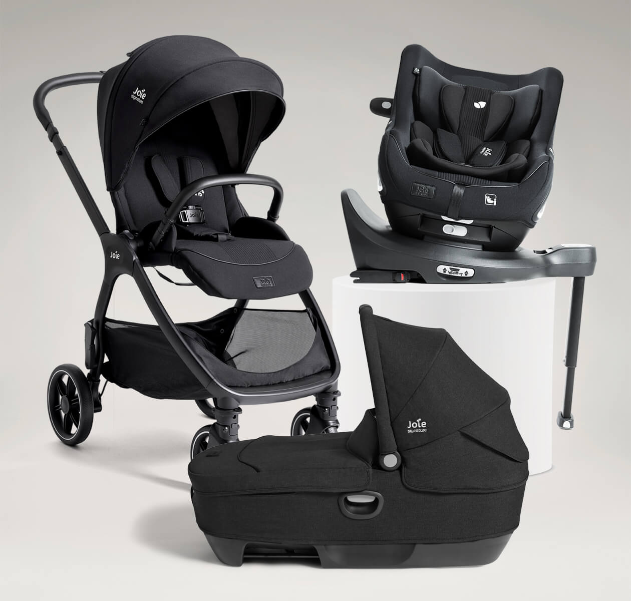 Joie Signature valora grow ready bundle including valora pushchair, i-Harbour E car seat, calmi R129 car cot and i-Base encore spinning car seat base, all in black.
