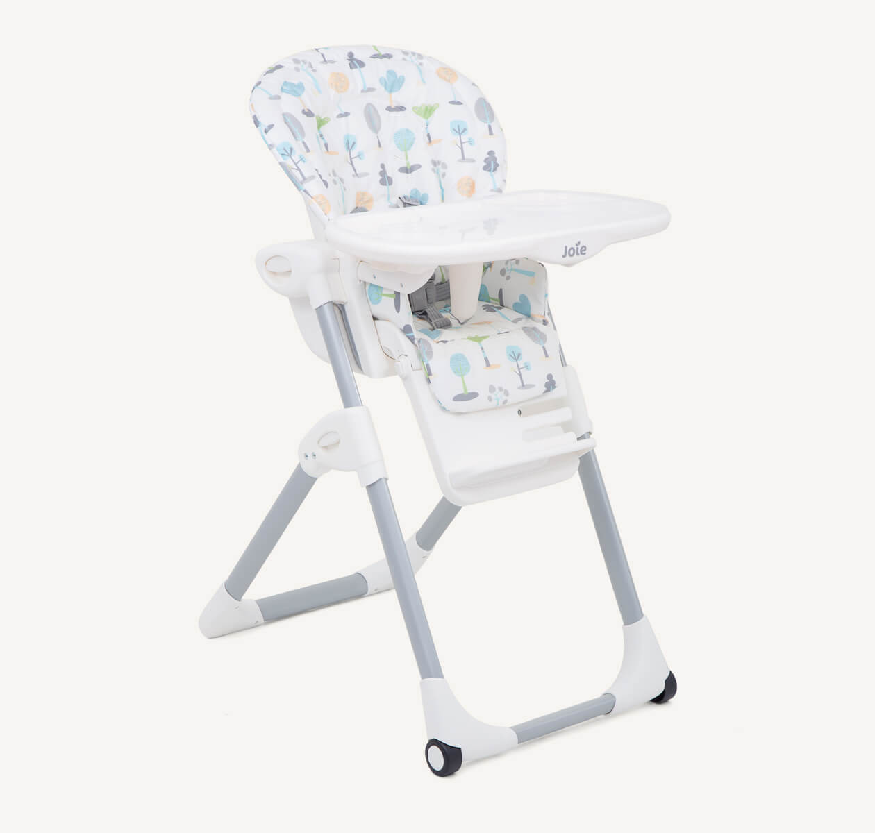 The Joie highchair mimzy in a multi-color print featuring illustrations of different trees from a right angle. 