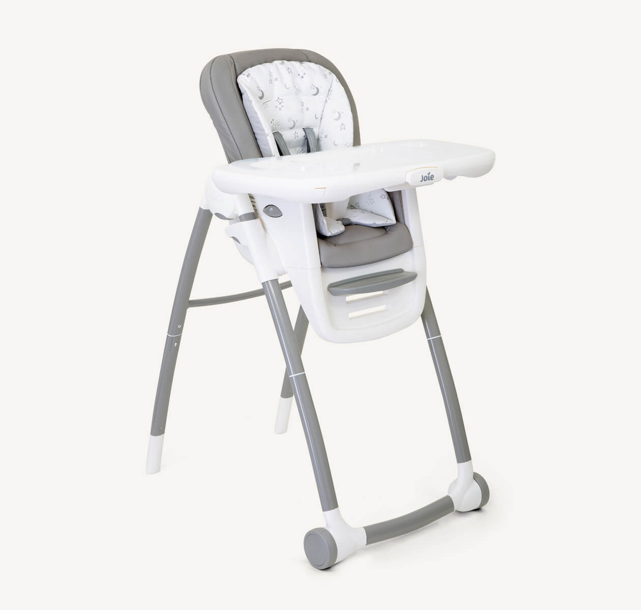 A multiply highchair with light grey and starts patterns seat, white tray with grey front wheels on a right angle.