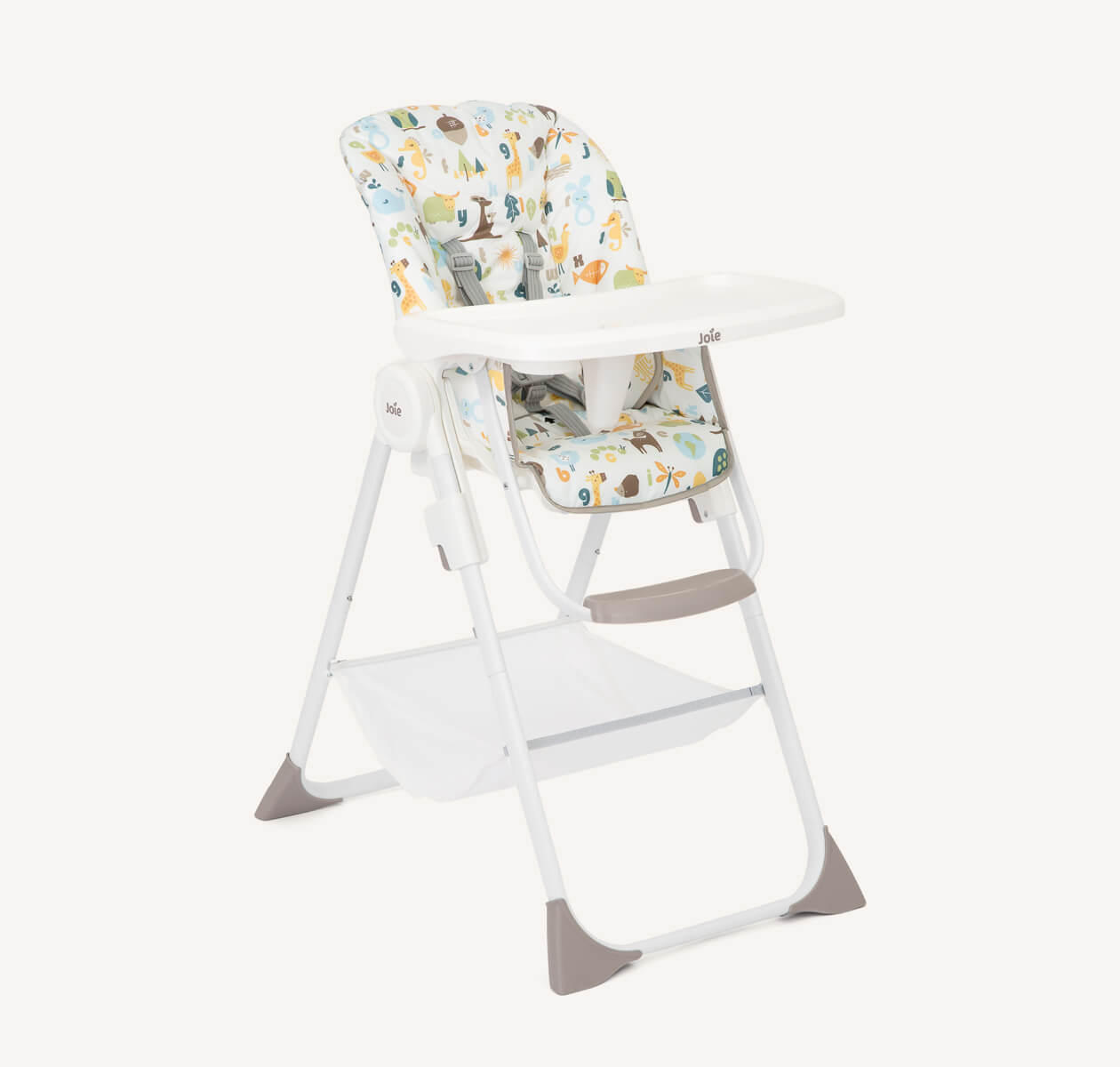 The Joie highchair Snacker 2in1 in a multi-color print featuring woodland animals and plants from a right angle. 