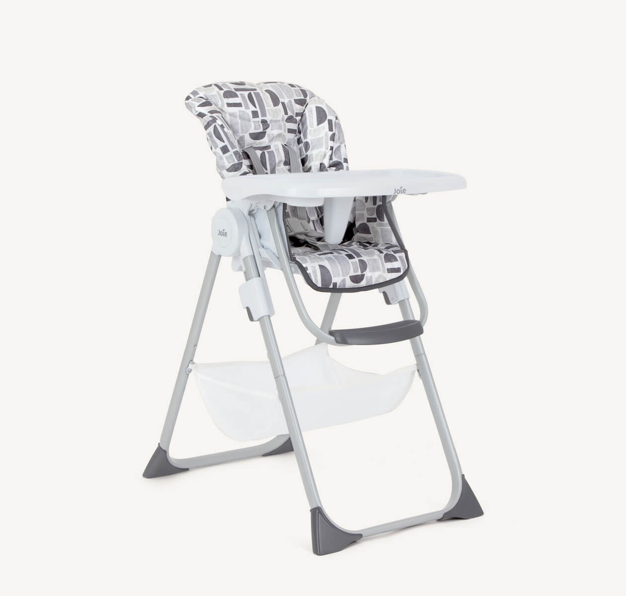 The Joie highchair Snacker 2in1 in a gray monotone print featuring geometric shapes in various shades and textures of gray from a right angle. 