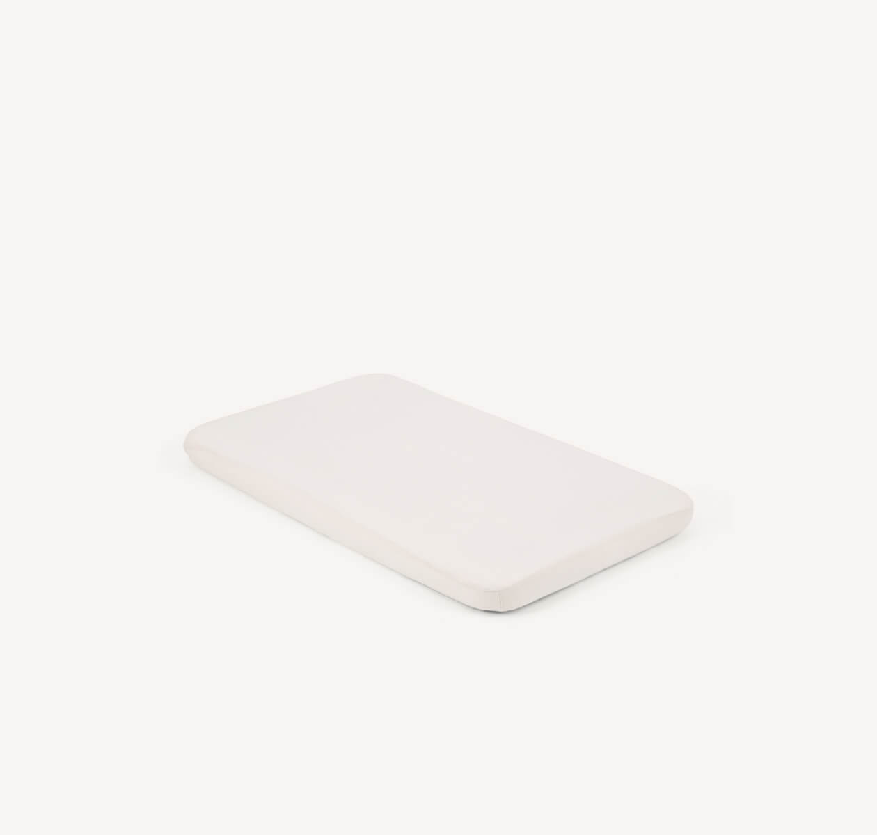  An off-white roomie sheet shown on a roomie mattress.