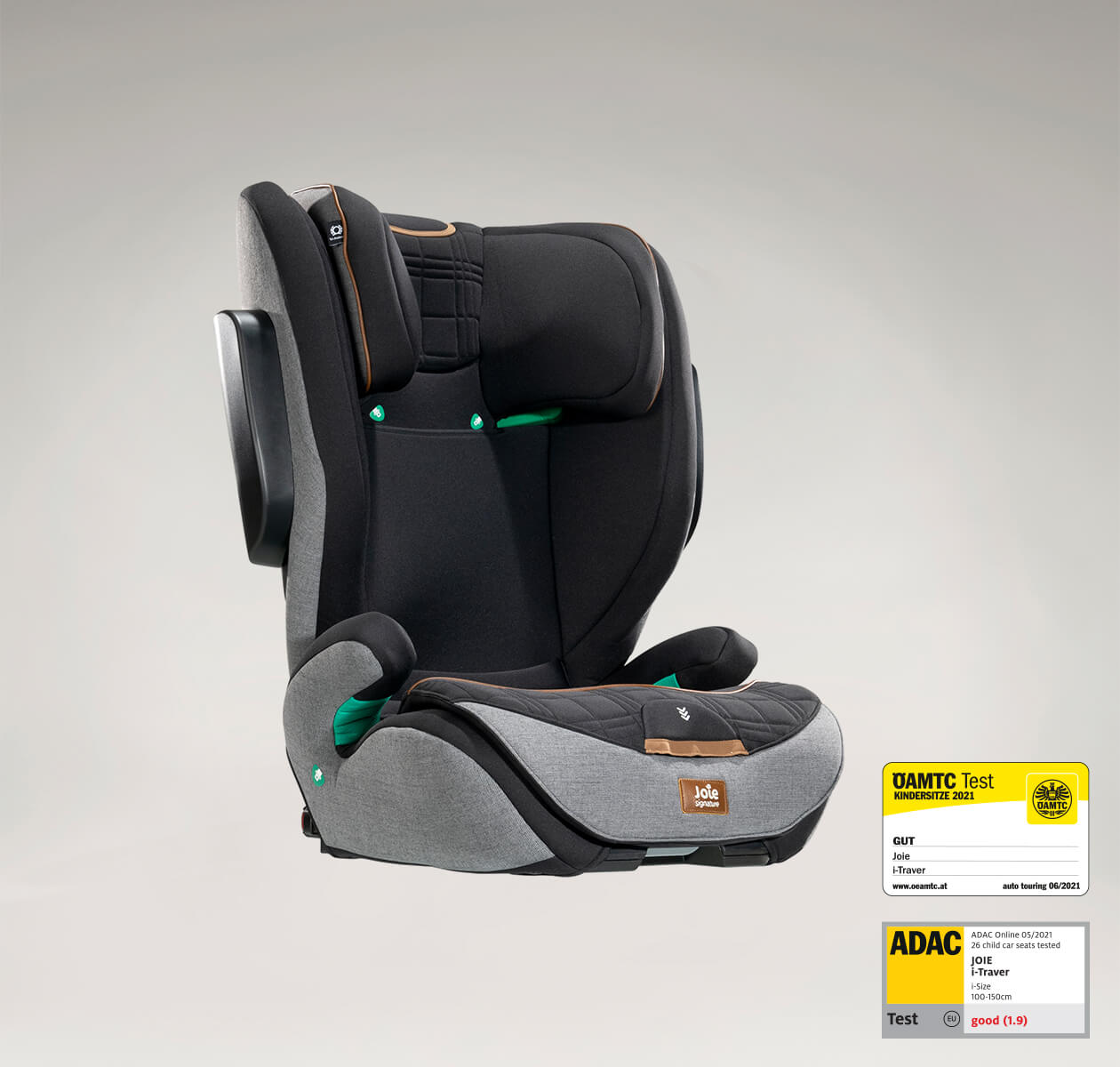  Joie i-Traver booster seat in black and gray at an angle, with the ADAC and OAMTC test labels in the lower right corner.