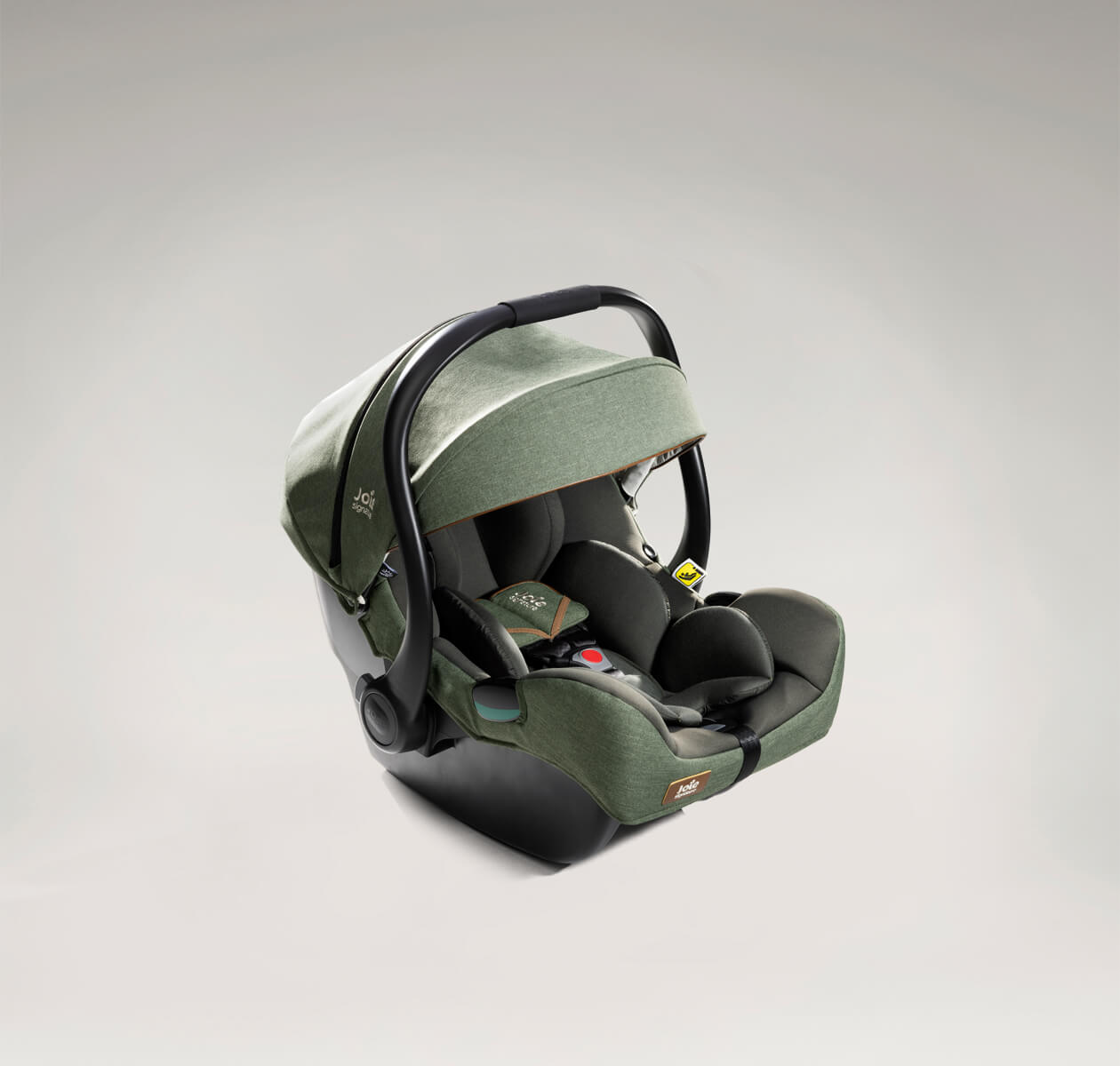 A green Joie i-Jemini infant car seat at an angle facing to the right