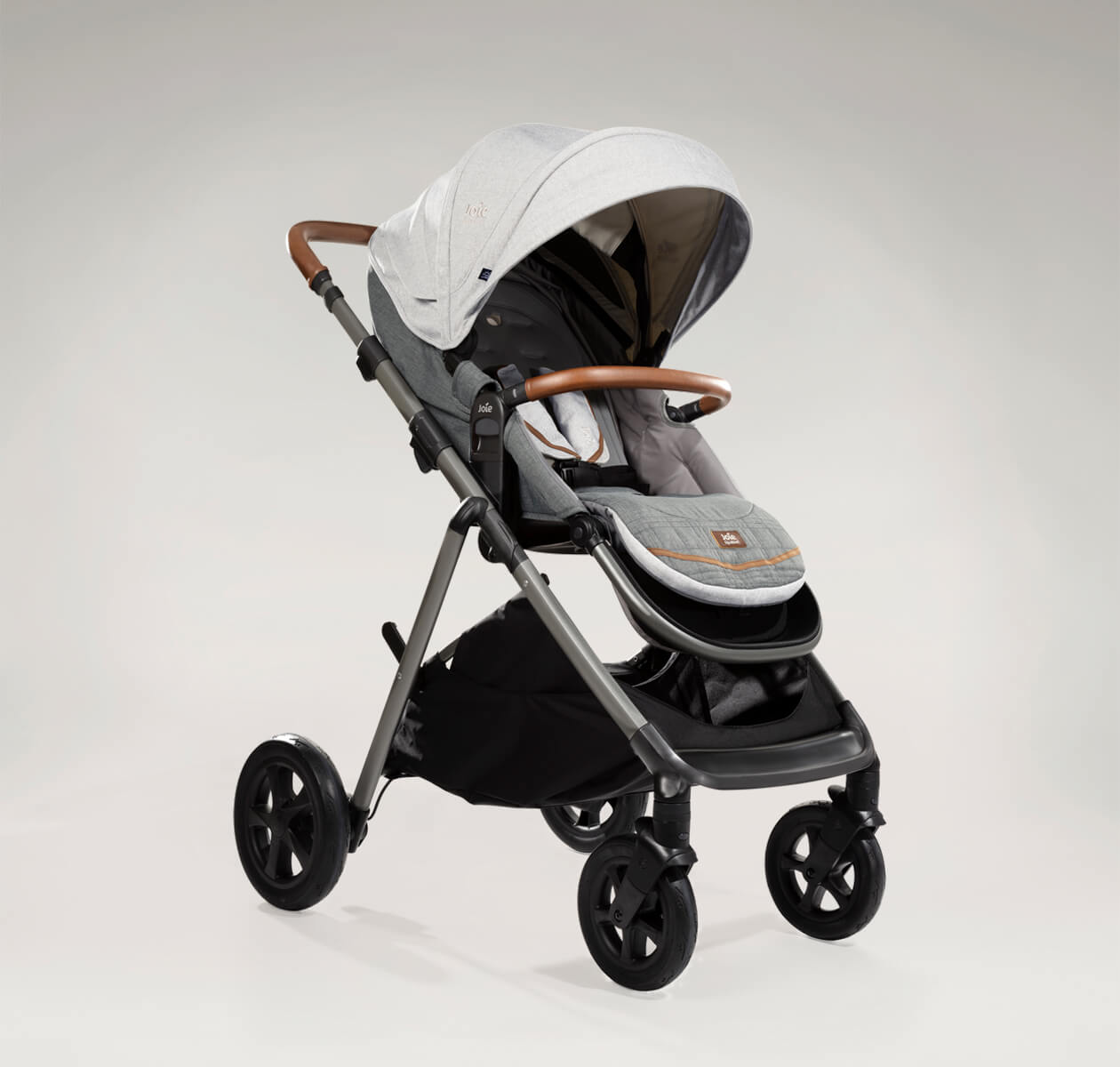 Joie aeria pram in light gray at an angle. 