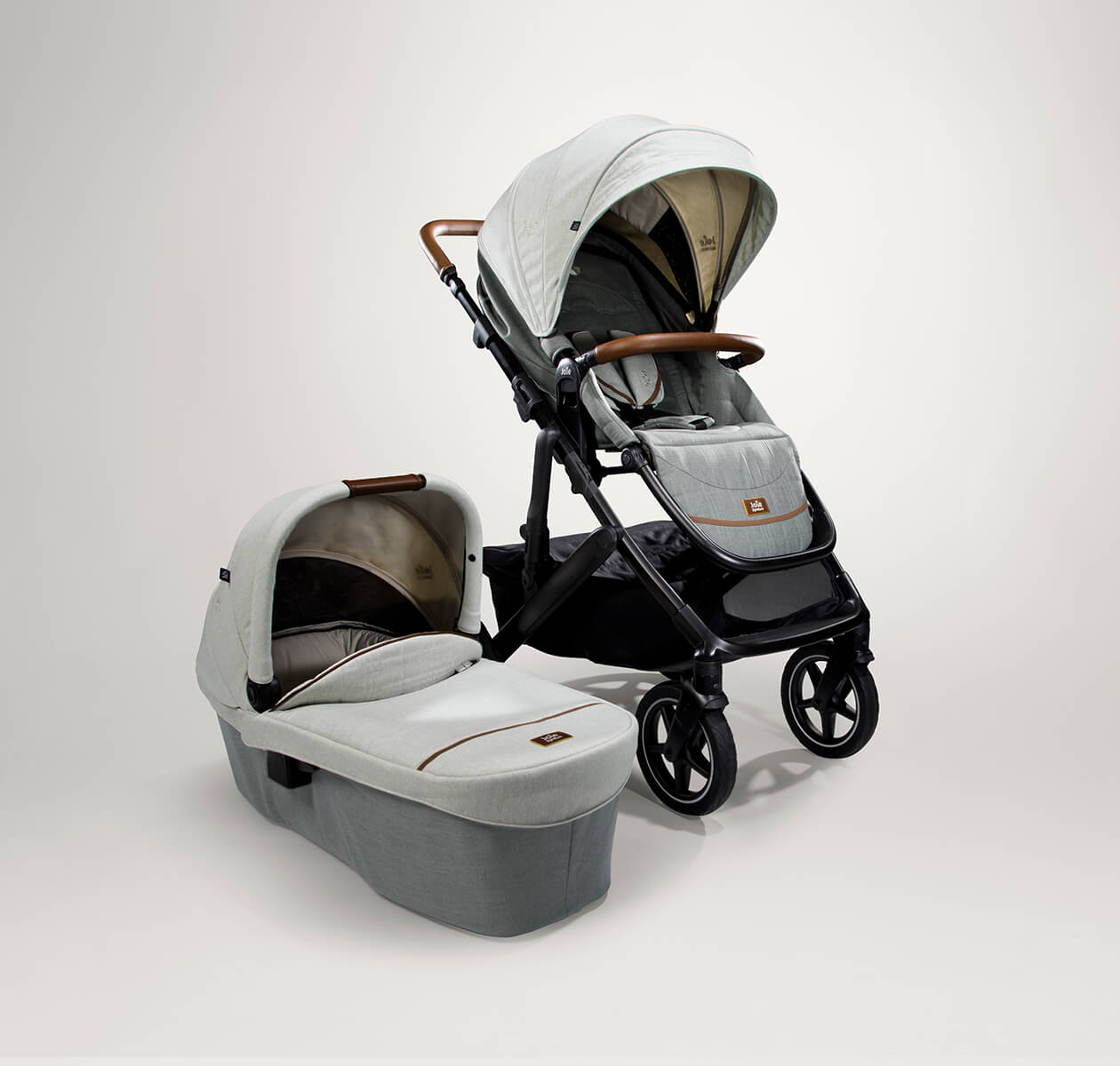 Joie signature vinca pram and ramble XL carry cot in gray at an angle 